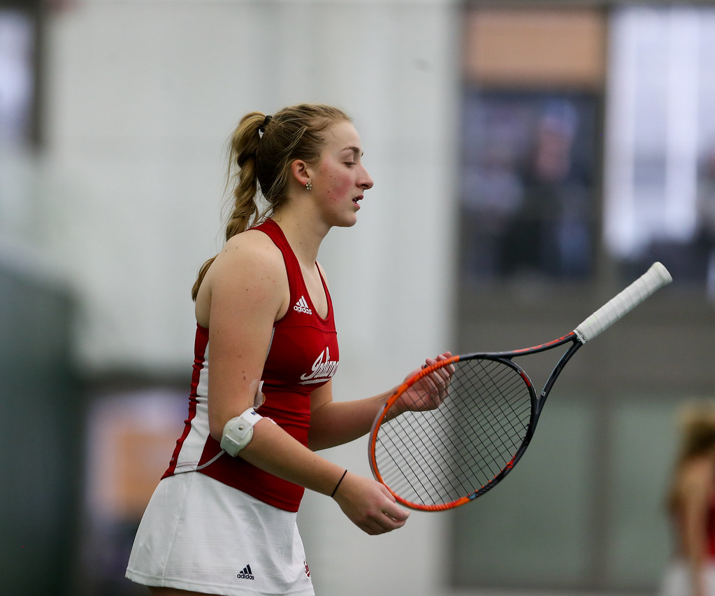 Kim Schmider spins her racket around between games during her singles match against Iowa's Aimee Tarun.