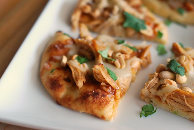 Thai-Style Chicken Flatbread - naan flatbread with peanut sauce, chicken, cheese, cilantro, and chopped peanuts! Bakes in just 8 minutes!