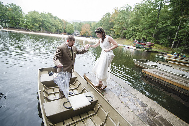 A celebratory trip around the lake for the newlyweds was in order, even on this rainy fall day. Wedding Photography at Douthat State Park by Craig Spiering Photography.