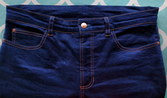 The front waist of hand made blue jeans.