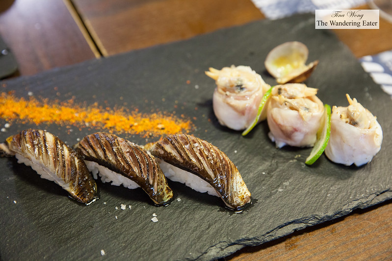 Plate of blowtiorched sardine nigiri with togarashi and clam & sea bass maki