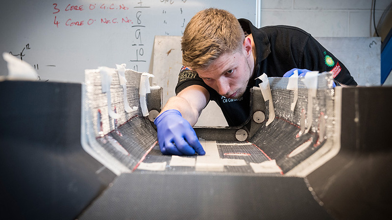Student works in lab on a racecar chassis