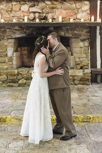 Newlyweds first kiss after getting married in the picnic shelter with family and friends at Douthat State Park. Wedding Photography by Craig Spiering Photography.