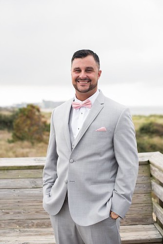 The handsome groom ready to meet his bride for their wedding. First Landing State Park wedding photo courtesy of Caitlin Gerres Photography