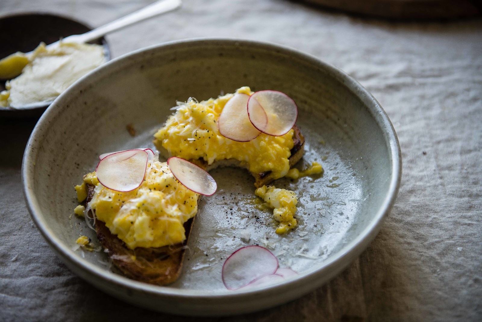buttered eggs on toast with radish & parsley
