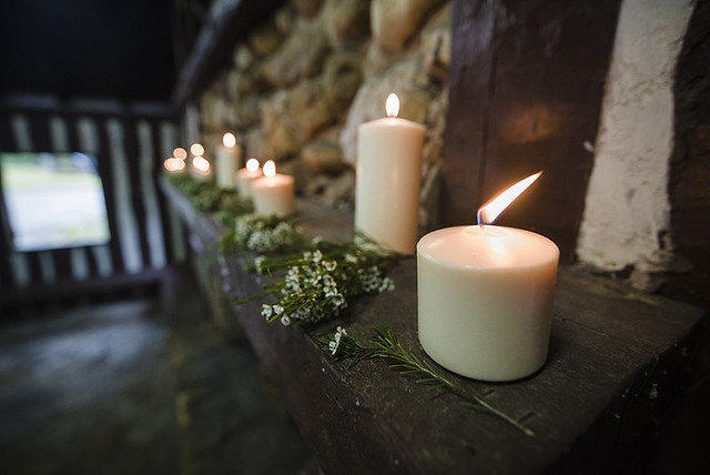 Candles light the mantle in the picnic shelter for the wedding ceremony. Wedding Photography at Douthat State Park by Craig Spiering Photography. 