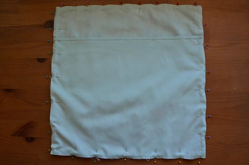13. Place second backing piece at other end, right side down with double-folded hem horizontal.
