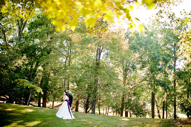 Together at last, happy Bride and Groom newlyweds arm in arm take in the beautiful fall scenery at the park - Fairy Stone State Park, Virginia - Wedding Photos by Natalie Gibbs Photography