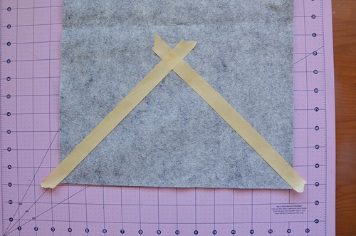 2. Flip the cutting mat around and place another piece of tape at 45-degrees from the corner.