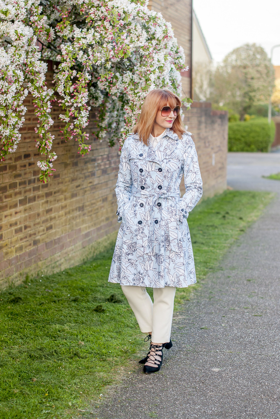 Spring fashion: Blue floral trench coat white trousers black lace-up ghillie shoes oversized 70s sunglasses | Not Dressed As Lamb, over 40 style