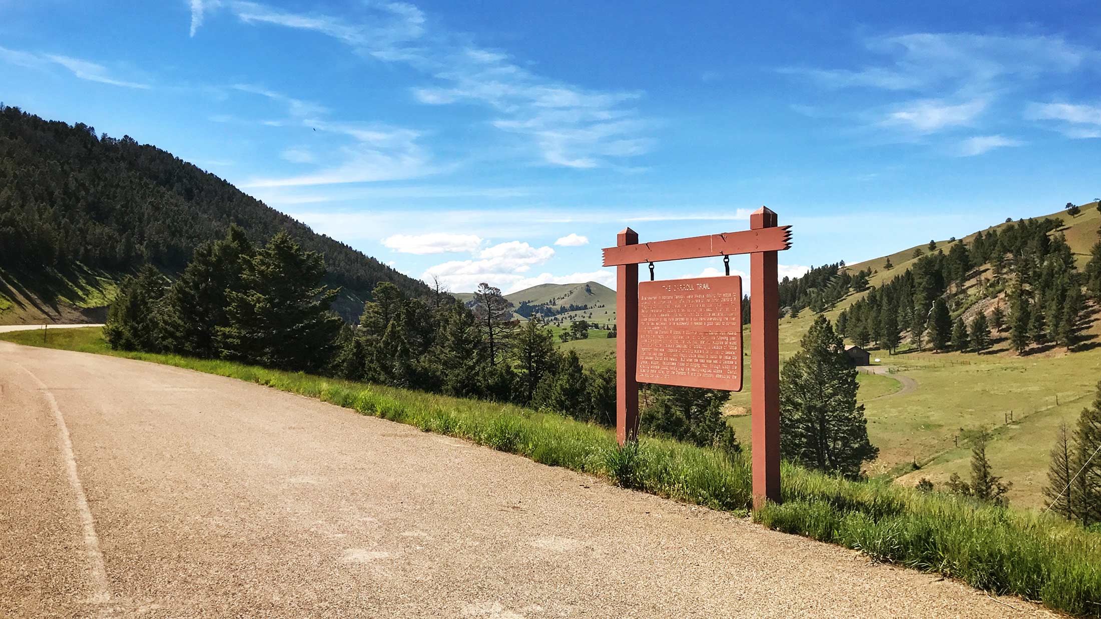 The Carroll Trail ran through the Little Belt Mountains right about where Highway 12 exists now. This sign has been placed here to commemorate its significance and the people who forged it. 