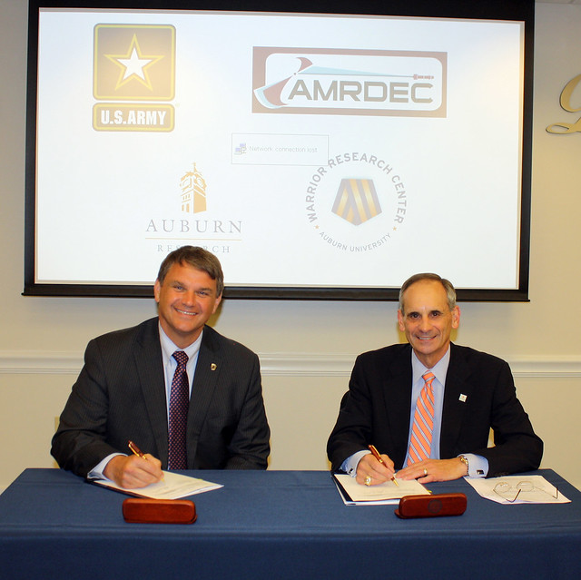 Jeff Langhout and John Mason sign a research agreement.