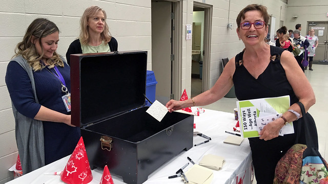 Eleanor Cowan submits a note for the Canada 150 time capsule at the Carya Society of Calgary