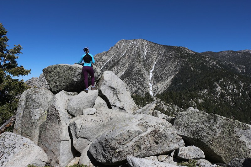 Vicki climbing the summit block of Castle Rocks