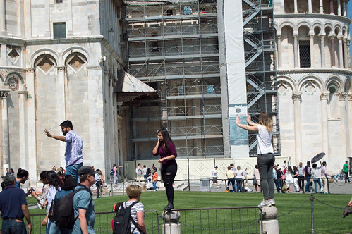 Tourists taking photos at the Leaning Tower of Pisa