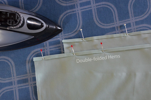 3. Double-fold a long edge of each of the backing pieces