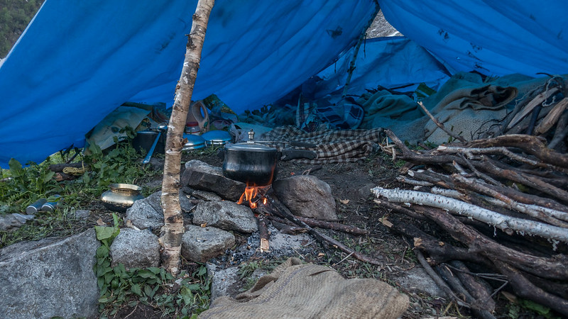 Dinner being prepared in shepherds' tarp shelter at Bhakartach BC