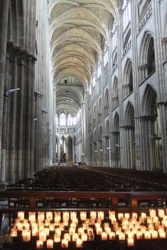 Interior of the Cathedral showing the Gothic vaulted ceilings and lit candles in front (Rouen, France)