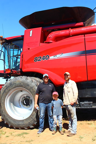Salesman Mike, Brady and John, posing by the new combine.