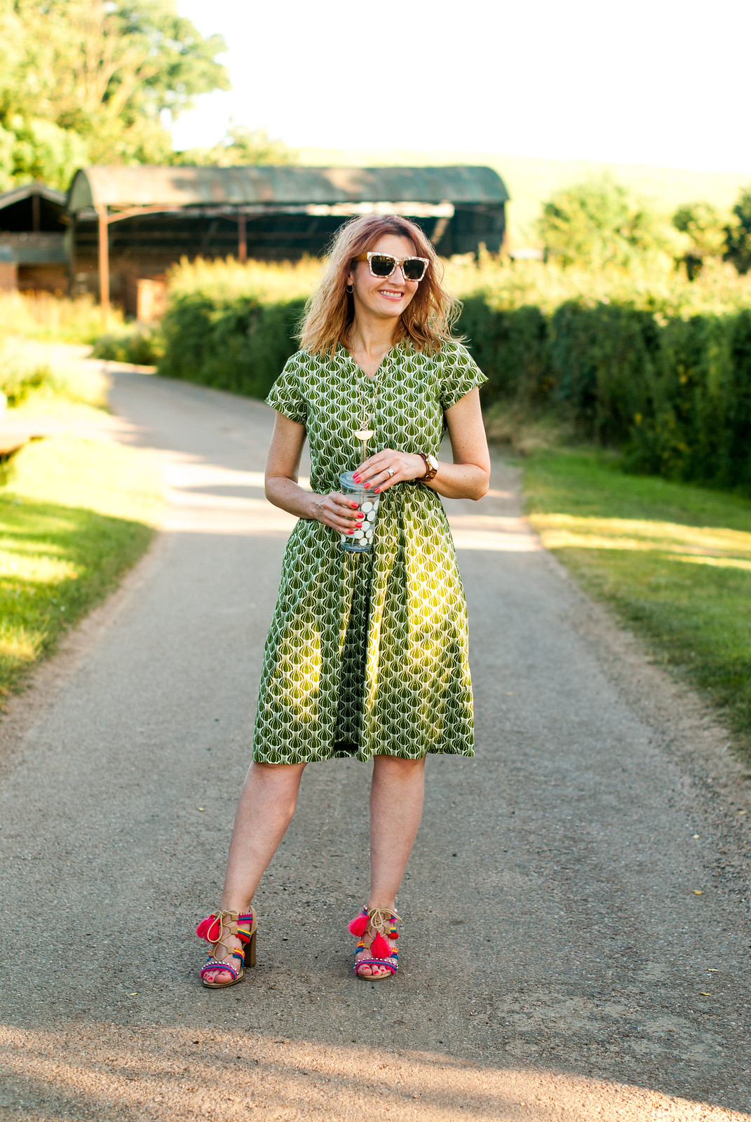Hot weather style: Printed green summer dress pompom and tassel embellished sandals | Not Dressed As Lamb, over 40 style