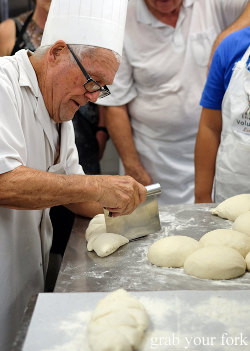 Making cuts into dough to make artisan bread