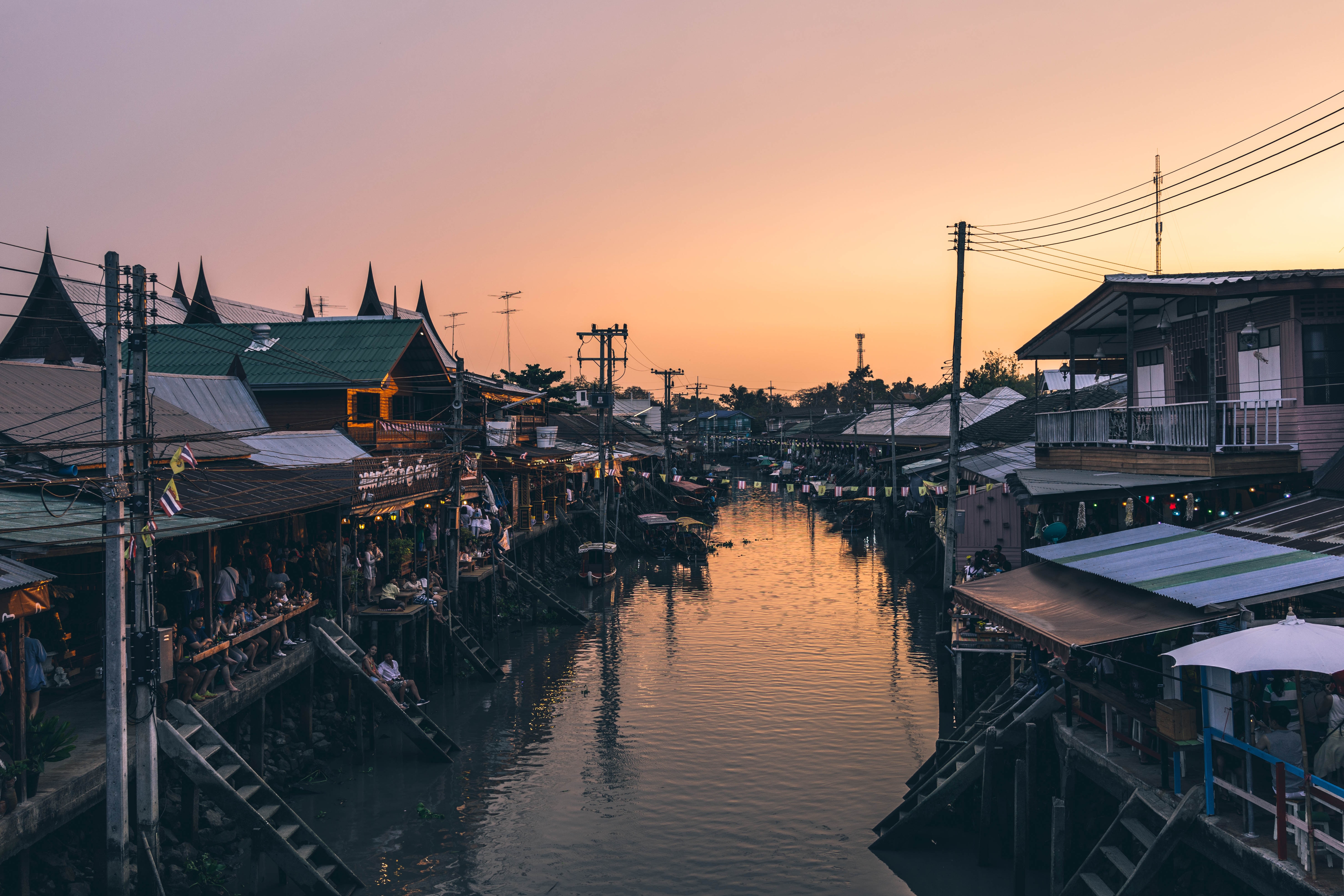 The Amphawa floating market in Samut Songkhram province, Thailand is a must-see destination for its food and natural beauty.
