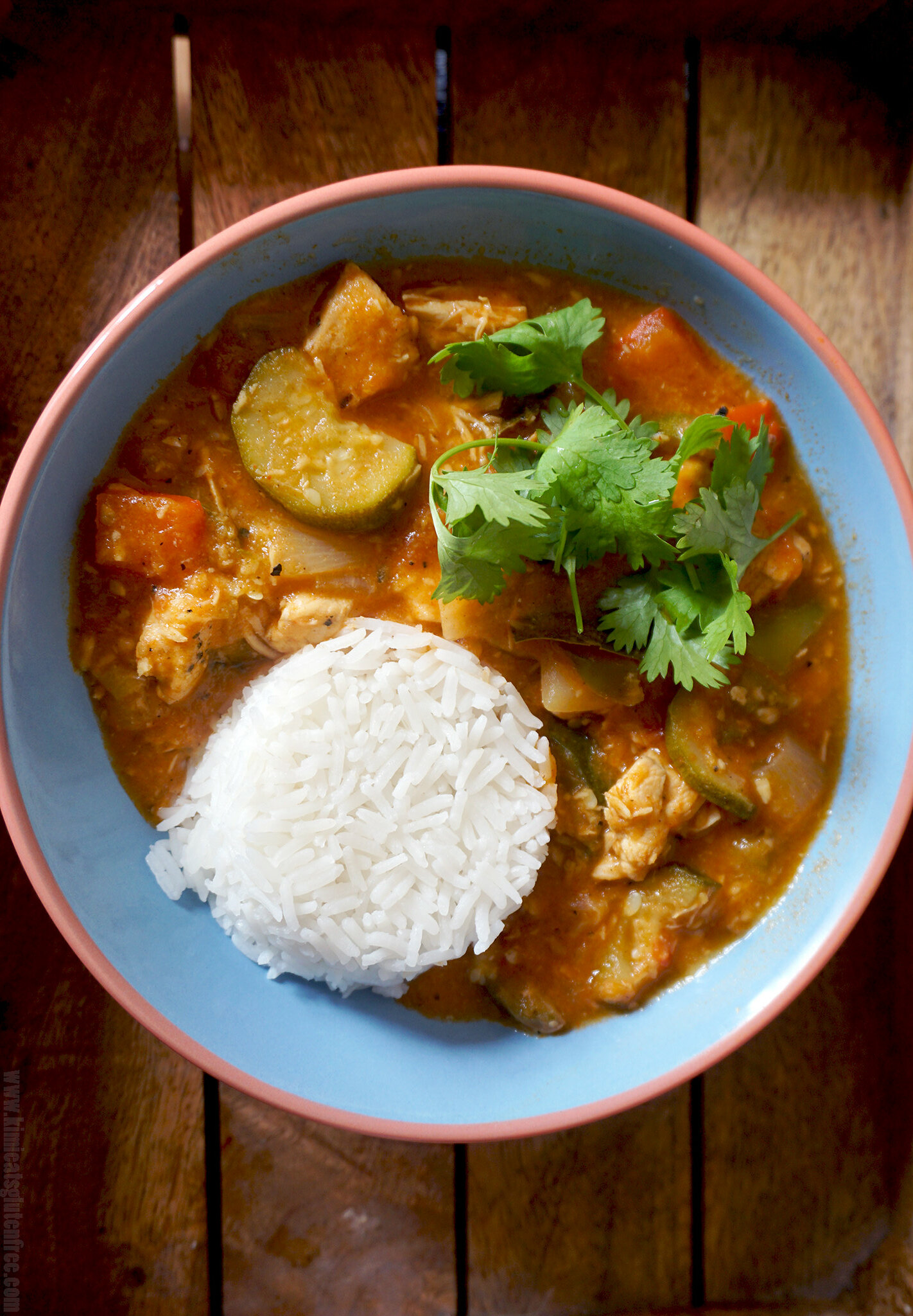 Healthy low carb coconut chicken stew served with rice and fresh coriander