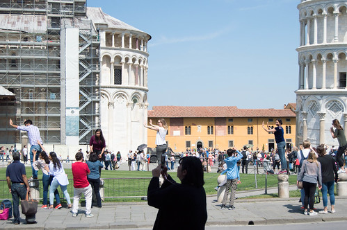 Tourists taking photos at the Leaning Tower of Pisa