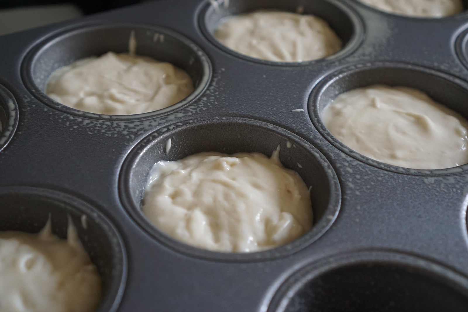 Baked gluten free crumpets making process | batter poured into muffin tin