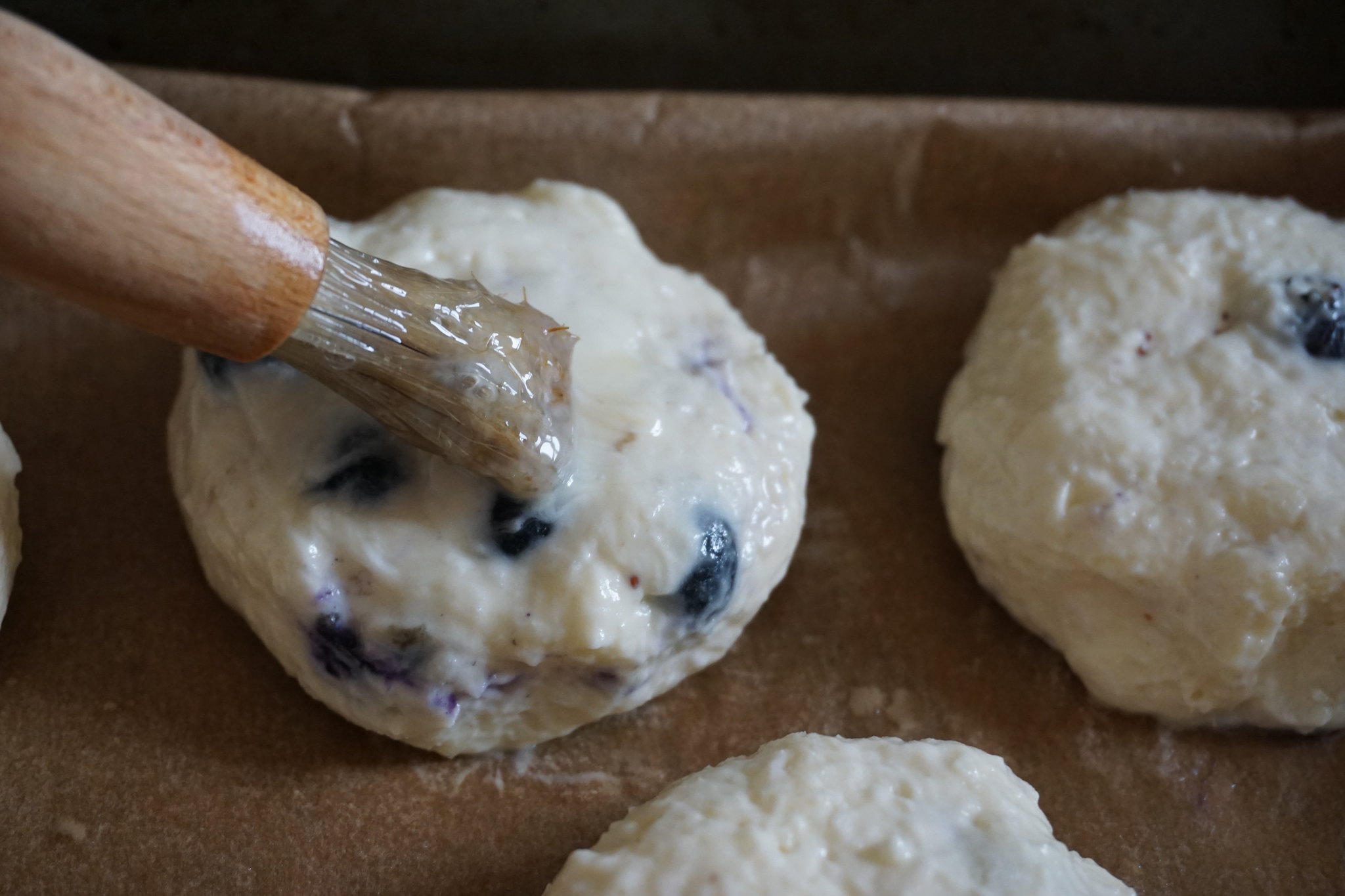 Brushing beaten egg over scone - gluten free coconut blueberry scones making process