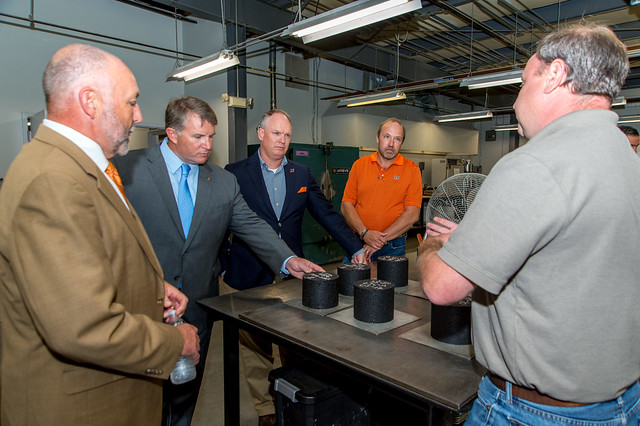 Auburn University President Steven Leath, left, Rep. Joe Lovvorn and Sen. Tom Whatley took a tour of NCAT’s research facilities led by NCAT board member Mel Monk and lab manager Jason Moore.
