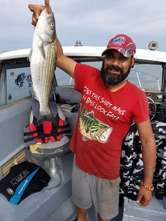 Elvin Phillip holds up a nice striped bass