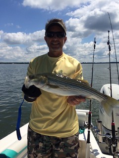 Herb Floyd holds up a striped bass