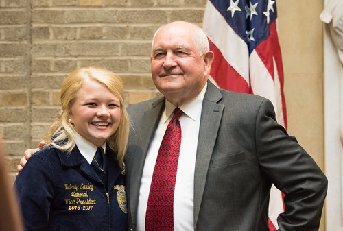 Valerie Earley poses with Secretary Perdue at the USDA Whitten Patio