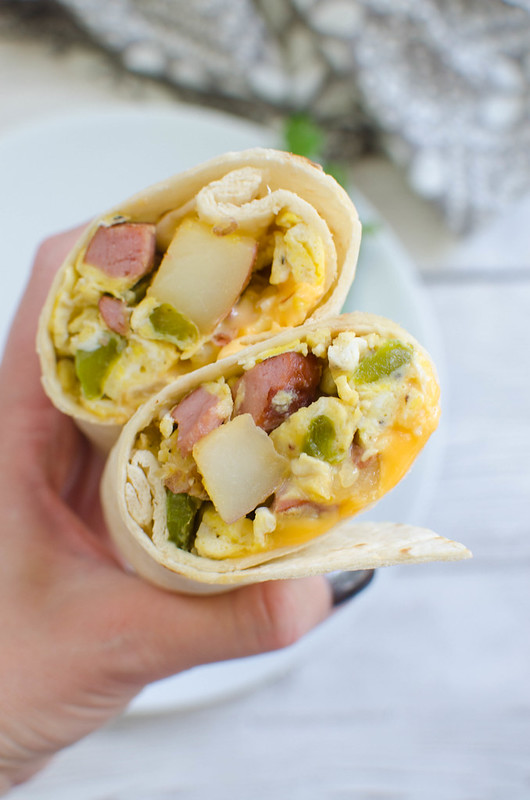 Kielbasa and Potato Breakfast Burritos - easy make ahead breakfast idea! Kielbasa, potatoes, and peppers rolled into tortillas with cheese and eggs. 