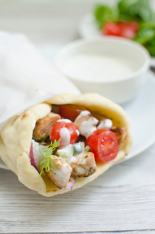 Easy Pork Gyros - delicious gyros in less than 30 minutes! Marinated pork wrapped in soft pita bread with veggies and tzatziki sauce. 
