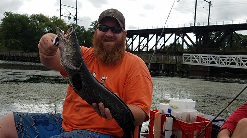 Vince Roberts holds up a northern snakehead he caught