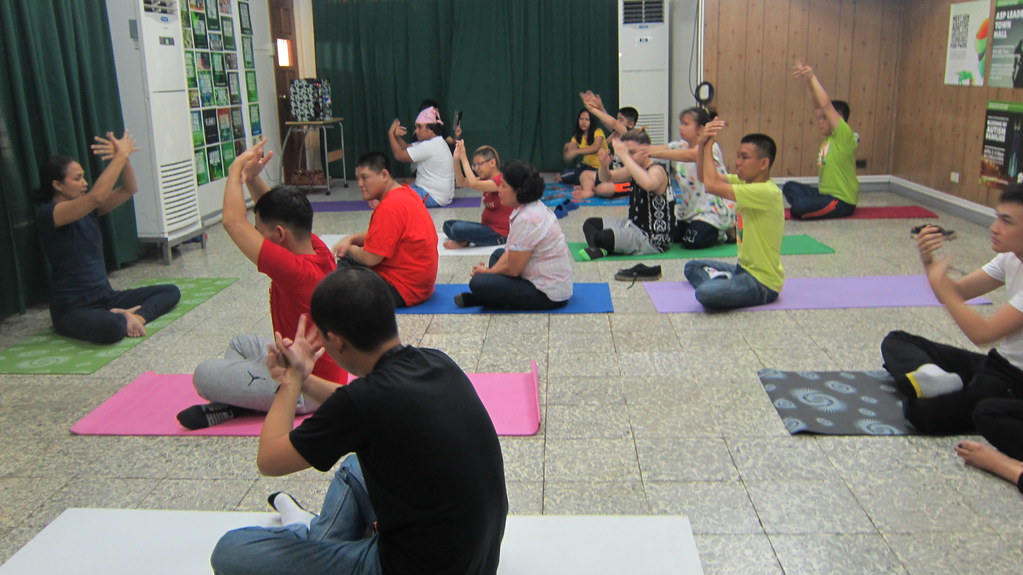The image shows Pweymates doing yoga during PweDay.