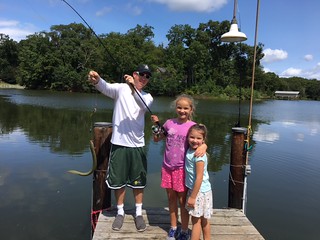 Family on dock with Eel Catch