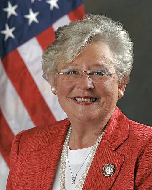 Pictured is Alabama Gov. Kay Ivey in a red jacket and pearls.