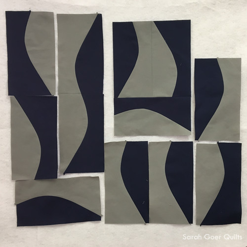 seven navy and grey gentle improv curve units and two larger chunks on design wall