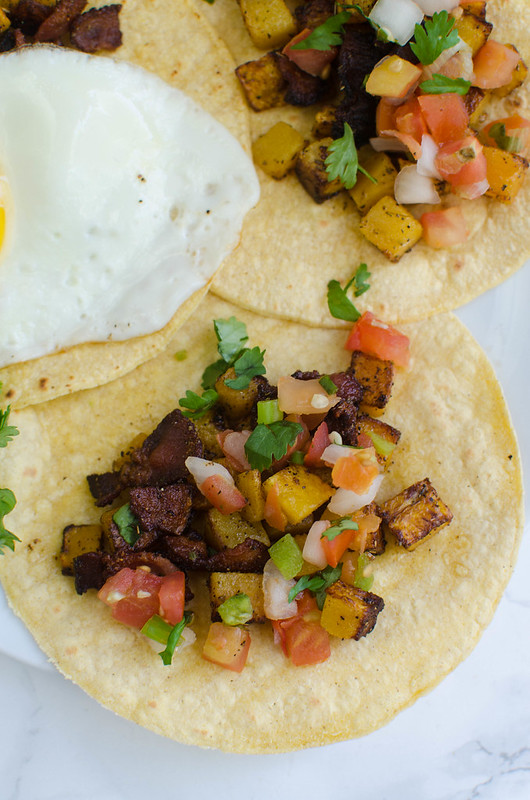 Bacon and Butternut Squash Breakfast Tacos - the best fall breakfast! Corn tortillas filled with bacon and butternut squash. Top with an egg, salsa, and fresh cilantro! 