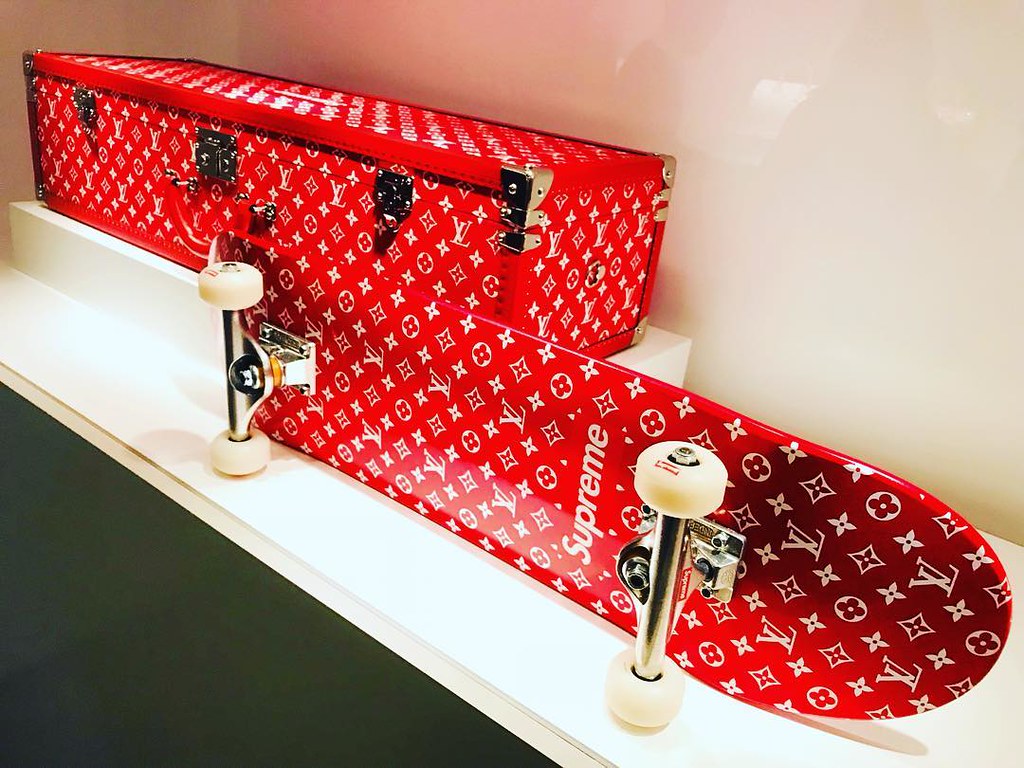 A LIMITED EDITION RED & WHITE MONOGRAM BOÎTE SKATEBOARD TRUNK WITH SILVER  HARDWARE BY SUPREME
