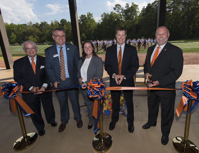 Auburn University officials cut the ribbon on the Band Practice Complex Sept. 29. The Auburn University Marching Band is in the background.