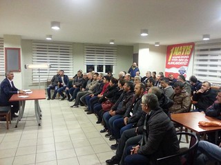 KT Deri factory workers sit in a room with Musa, Deriteks President, taking part in collective bargaining negotiations.