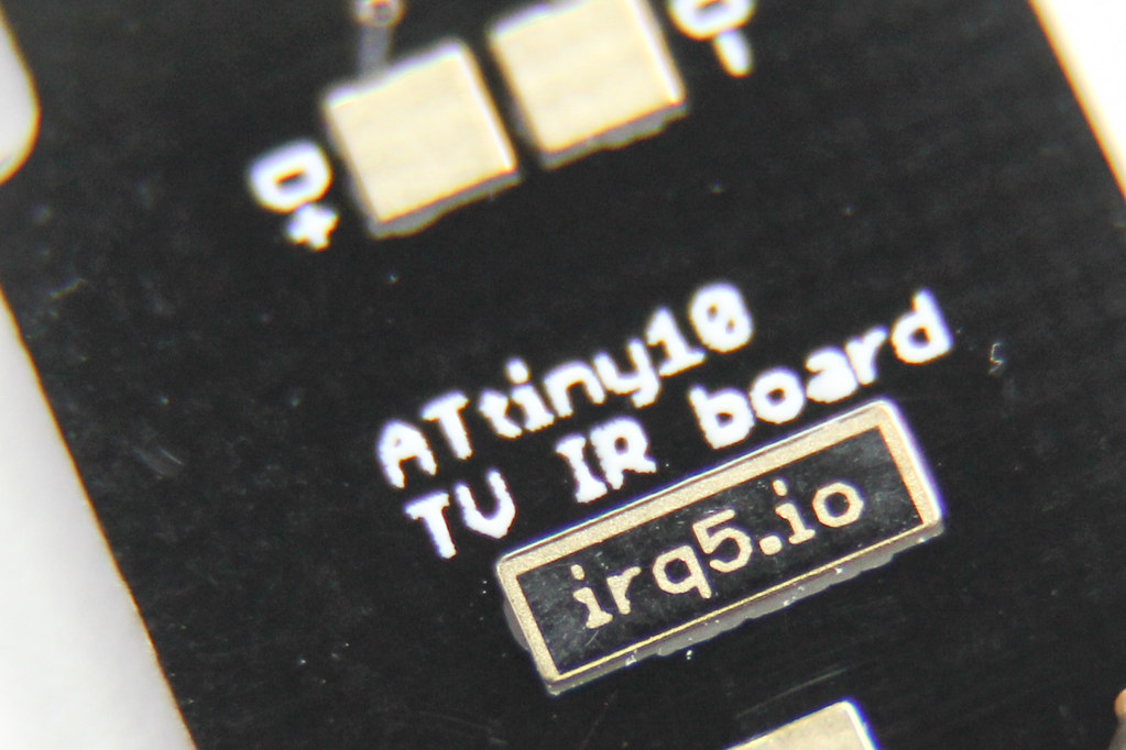 close-up photo of PCB reverse side, middle part where the board title and website is