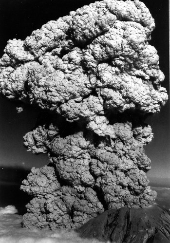 Grayscale image shows a tall Plinian eruption column. It's in the classic cauliflower style.
