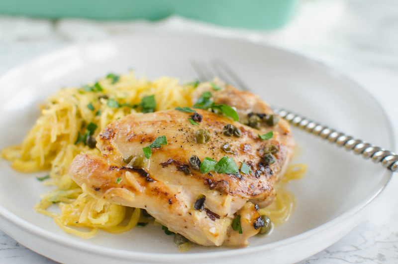 Paleo Chicken Piccata - chicken thighs with a delicious lemon and caper sauce, served over spaghetti squash. You're going to love this healthier version of the classic! 