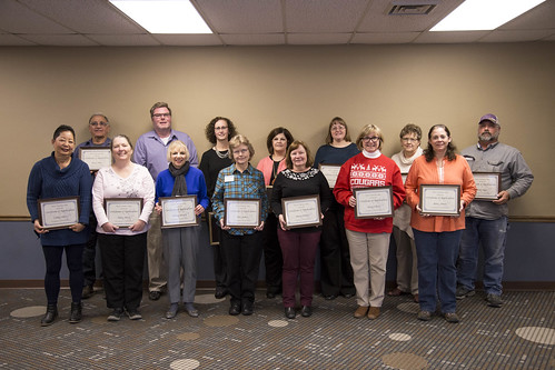 Members of faculty and staff hold their certificates of appreciation recognizing years of service during the December President's Forum