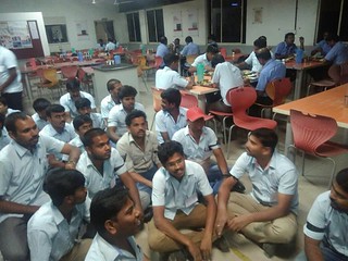 workers sit on the ground of the dining room, refusing to eat on a hunger strike to protest illegal and unethical treatment by management at Avery Dennison Pvt. Ltd. in Bangalore, India